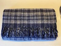 Scarf folded showing check pattern and fringe