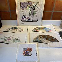 Group shot of six painted canvases: large kimono, four fans, small square kimono