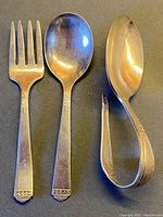 Spoon, fork and curved spoon full view