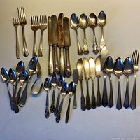 Overview of entire 34-piece silver-plate flatware assortment