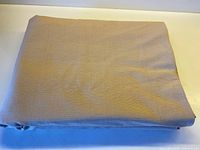 Folded bolt of sand-coloured linen-cotton fabric