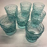 seven turquoise crinkle footed glasses grouped