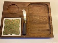 overview of cheese board showing tile insert, knife, recessed sections
