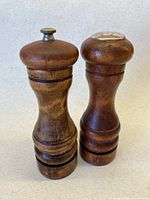 Front view of pepper grinder and salt shaker