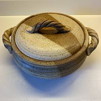 Top and side view of lidded casserole showing overall form, handles and glaze