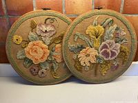 Both round hooked floral pieces in hoops