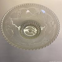 Top view of clear glass ceiling shade showing scalloped rim and floral pattern