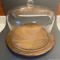 Wooden plate with glass dome assembled