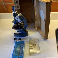 Microscope, wooden case, eyepieces, slide holders