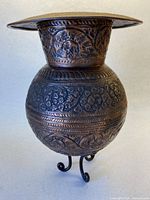 Full view of copper vessel on three wrought iron legs