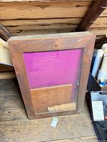 Wood table top with glass panel and leg parts visible