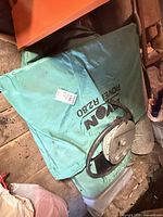 Rolled Avon Rover R2.80 inflatable boat with manual pump visible