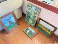 Group shot of all four framed paintings showing subjects and frames