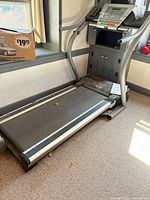 Full view of NordicTrack treadmill showing console, belt, and manual
