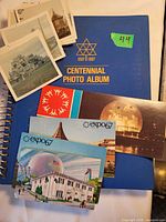 Group shot of album cover, postcards and loose photos