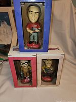 Three boxed Pep Boys bobbleheads stacked to show front windows