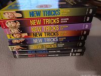 Stack of all eight New Tricks DVD seasons showing spines