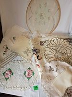 Overall view showing framed centerpiece, napkins, crochet placemat and additional linens