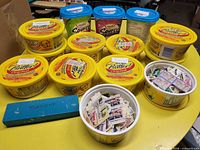 Overview of yellow tubs and blue box filled with stamps
