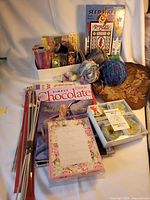 Overview of entire lot with ribbons, yarn, knitting needles, books, stationery, bag