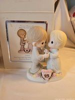 Figurine beside its original box