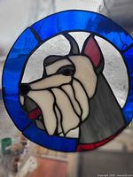 Front view of circular stained glass dog hanger showing colours and design