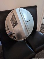 front view of one mirror on chair showing reflective surface
