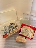 Overview of cookie press, icing kit box, chocolate mold box