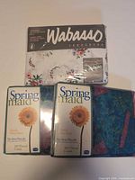Packaged Wabasso and Springmaid sheets with teal abstract sheet