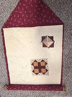 Quilt block planner unrolled showing unfinished blocks on cream surface