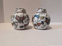 pair of small ginger jars with lids, floral bird decor