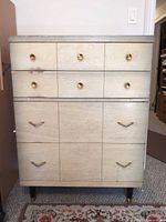 Full front view of tallboy dresser showing drawers, hardware and legs