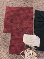 Red quilted square, green folded-star square, backing fabrics, piping, threads, instruction sheet