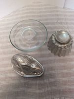 overview of all three molds: glass round, tin fluted, tin rabbit
