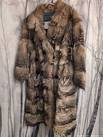 Front view of vintage fur coat hanging