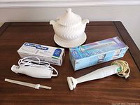 Group shot showing hand blender, electric knife, soup tureen with underplate and both product boxes