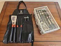 Apron laid out with three tools inserted; case beside