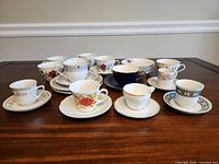 Group shot of assorted teacups and saucers on table