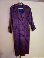 Front view showing double-breasted buttons, epaulettes, length