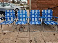 Front view of all four aluminum chairs side by side