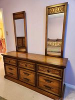 dresser with two mirrors showing carved details and finish