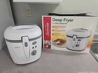 Fryer beside original retail box displaying model and capacity