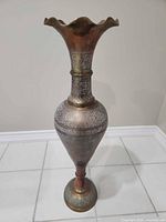 Full front view showing entire brass vase and engraved pattern