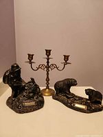 Group view of candelabra and two figurines