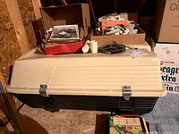 Full view of rooftop carrier showing beige lid, black base, overall design