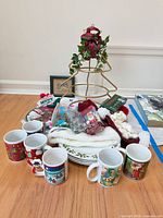 Group shot showing mugs, plates, stand, bulbs, linens and other items