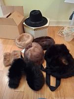 All hats, cuffs and stole grouped on floor for overview