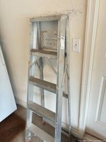 Front view of full ladder showing height, steps, wear