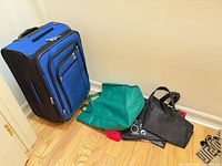 Suitcase and four reusable bags on floor
