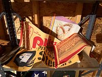Three folded vintage pennants on shelf